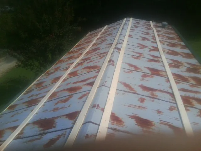 Rusted metal roof panels with new wood purlins before replacement — Storm Damage Roof Repair in Ava by Roofing Brothers
